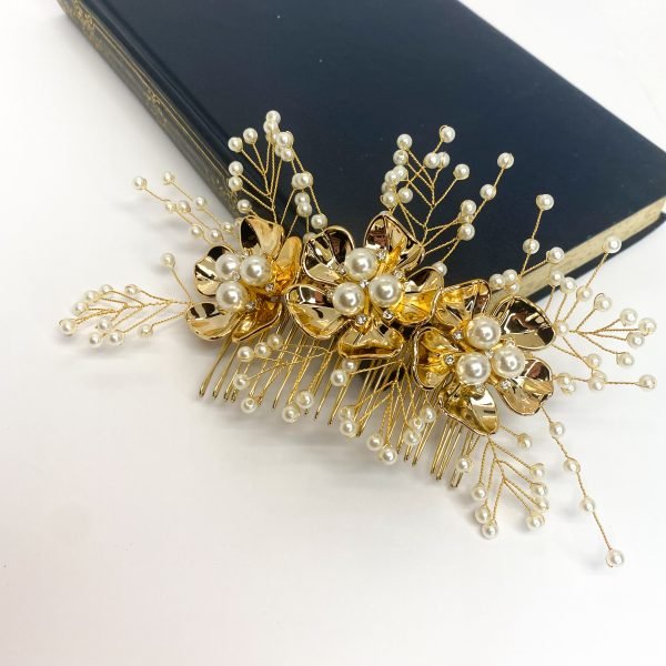 Saraden Designs Millinery Aterlier bring you Yarrow. Add a little something special to your day with this beautiful hair comb. Yarrow includes a scattering of cream pearls surrounding 3 gold flowers with pearls and diamanté decor which draws the eye and gives this hairpiece a real depth. It is a timeless choice for almost any occasion. It has been created from a lightweight tarnish-free gold wire and 20-tooth gold comb, which allows this piece to be moulded and fit neatly into any hairstyle. Whether you're looking to add a touch of elegance to an up do or a romantic flair to loose waves, Yarrow is sure to impress. Yarrow measures approximately 18cm in length, making it the perfect accent to your wedding day look. The Yarrow design is a great choice to wear with a veil and can be left in the hair once a veil has been removed, providing a beautiful transition from ceremony to reception. 