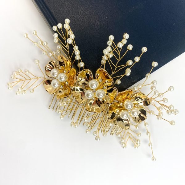 Saraden Designs Millinery Aterlier bring you Yarrow. Add a little something special to your day with this beautiful hair comb. Yarrow includes a scattering of cream pearls surrounding 3 gold flowers with pearls and diamanté decor which draws the eye and gives this hairpiece a real depth. It is a timeless choice for almost any occasion. It has been created from a lightweight tarnish-free gold wire and 20-tooth gold comb, which allows this piece to be moulded and fit neatly into any hairstyle. Whether you're looking to add a touch of elegance to an up do or a romantic flair to loose waves, Yarrow is sure to impress. Yarrow measures approximately 18cm in length, making it the perfect accent to your wedding day look. The Yarrow design is a great choice to wear with a veil and can be left in the hair once a veil has been removed, providing a beautiful transition from ceremony to reception. 