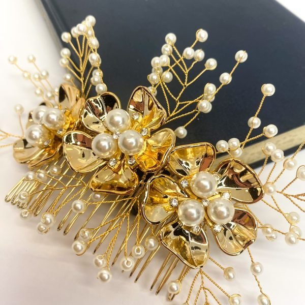 Saraden Designs Millinery Aterlier bring you Yarrow. Add a little something special to your day with this beautiful hair comb. Yarrow includes a scattering of cream pearls surrounding 3 gold flowers with pearls and diamanté decor which draws the eye and gives this hairpiece a real depth. It is a timeless choice for almost any occasion. It has been created from a lightweight tarnish-free gold wire and 20-tooth gold comb, which allows this piece to be moulded and fit neatly into any hairstyle. Whether you're looking to add a touch of elegance to an up do or a romantic flair to loose waves, Yarrow is sure to impress. Yarrow measures approximately 18cm in length, making it the perfect accent to your wedding day look. The Yarrow design is a great choice to wear with a veil and can be left in the hair once a veil has been removed, providing a beautiful transition from ceremony to reception. 