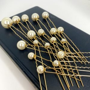 Saraden Designs Millinery Add a little something special with these beautiful hair pins. This set comes in a pack of 18 with various sized pearls on the top of gold pins. It is a timeless choice for almost any occasion. These pins can be molded and fit neatly into any hairstyle. They are a great choice to wear with a veil and can be left in the hair once a veil has been removed. Whether you're looking to add a touch of elegance to your wedding day look, or simply want to elevate your everyday style, these hair pins are the perfect accessory for a bride on her wedding day